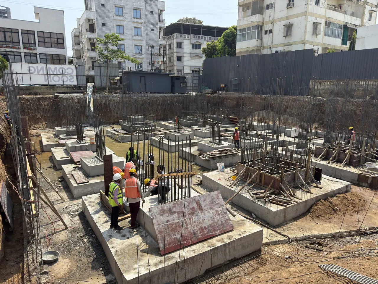 Workers in safety gear casting footings at Shreeji Elora