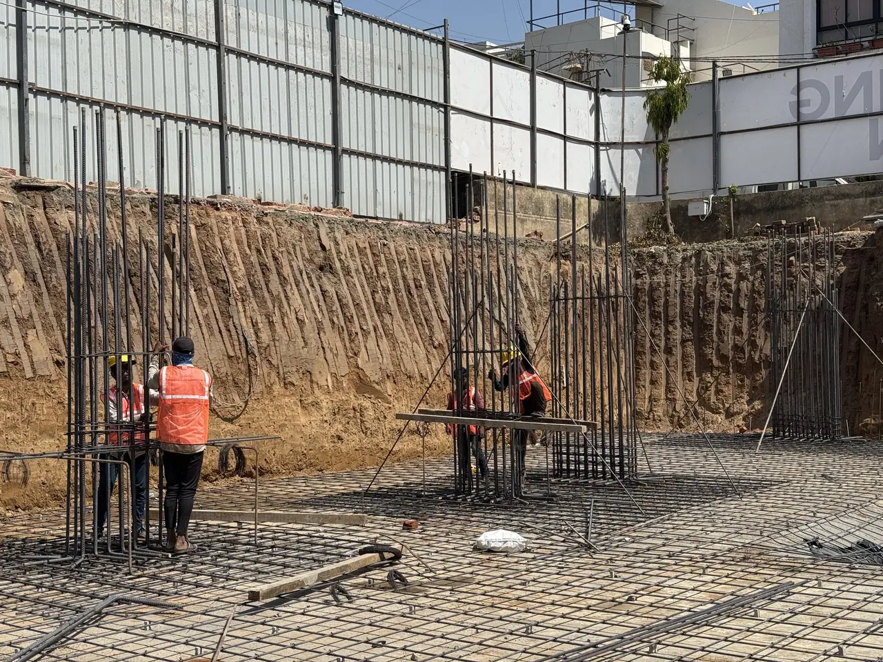 Workers tying raft reinforcement and column cages at Shreeji Elora